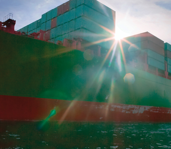 Container Ship Photo with Lens Flare from Sun - Hero 600x522