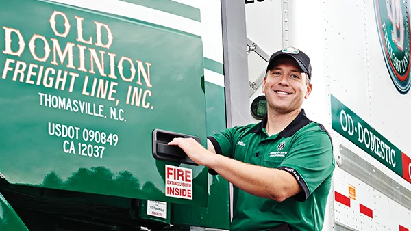 DRIVER_GETTING_IN_TRACTOR_SMILING_UNIFORM_TRAILER_600x338.jpg