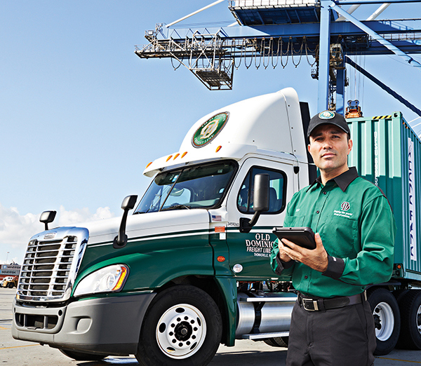 OD Driver with tablet at dock with shipping container in the background - 600x522