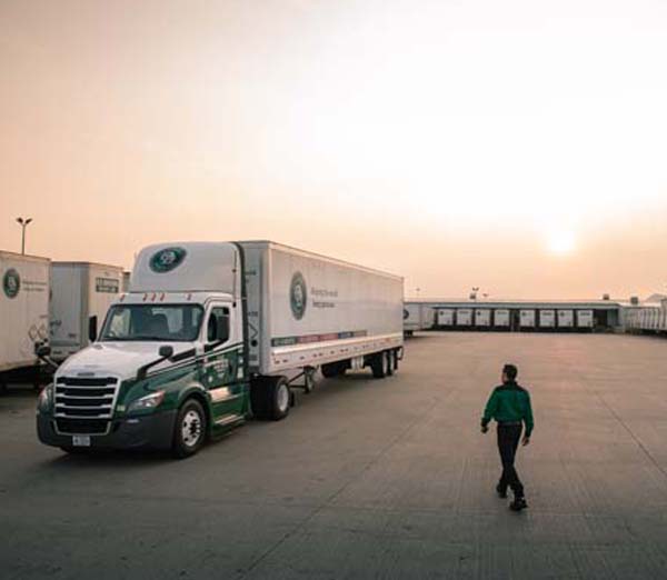 Truck_Tractor_Trailer_Van_Driver_WalkingToTruck_Dock_Dusk_600x522.jpg