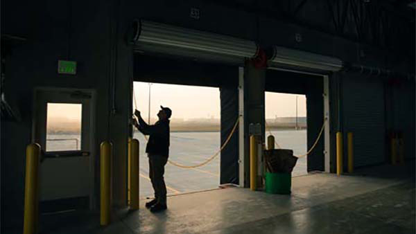 Dock Workers Rolling Up Dock Door